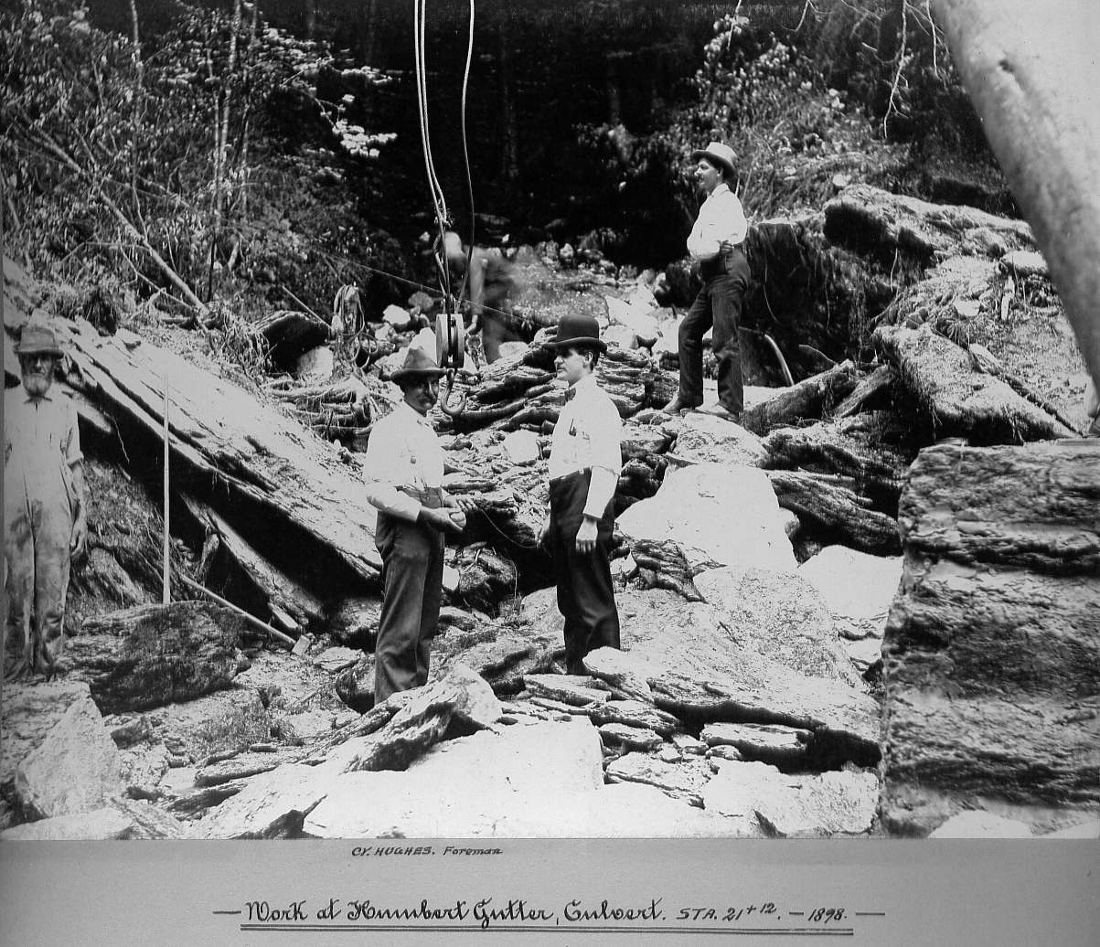 Men standing on rocks in culvert